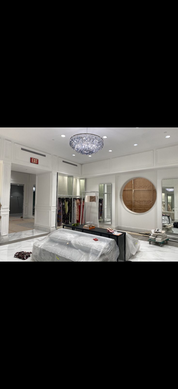 Boutique interior with protective coverings during painting project