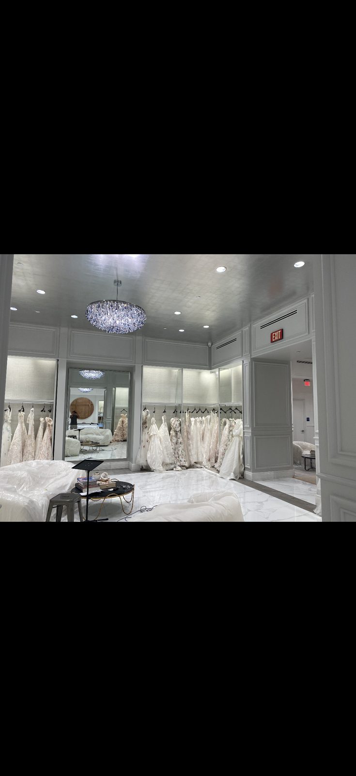 Bridal boutique with metallic silver ceiling finish and crystal chandelier