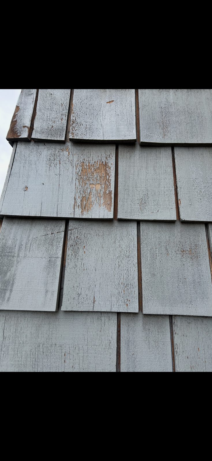 Exterior weathered shake siding before painting