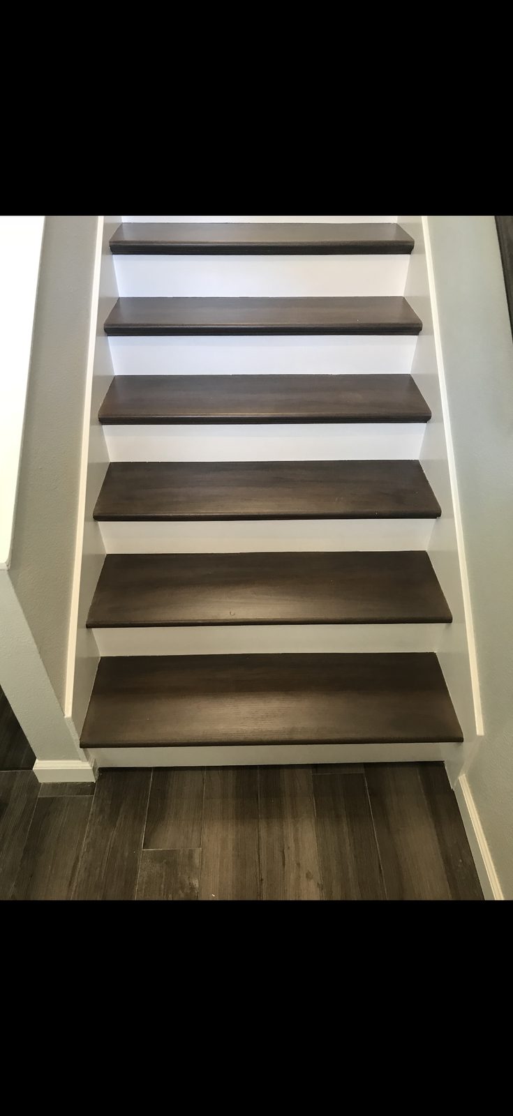 Finished stairs with dark stained treads and white risers